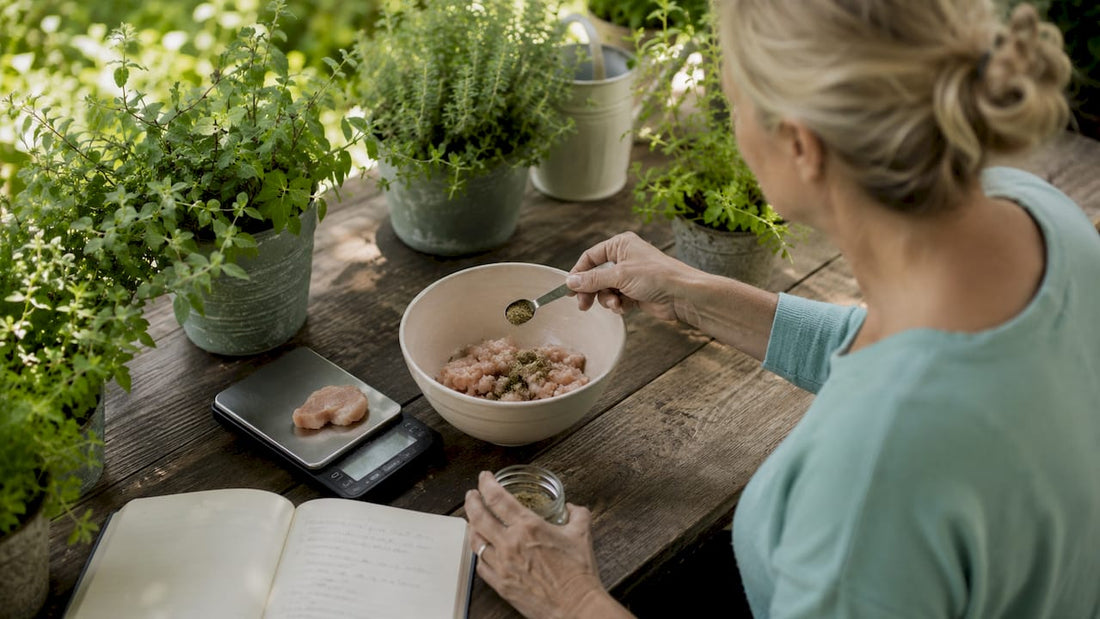 Woman preparing homemade dog food weighing ingredients